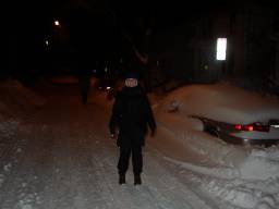 The blizzard has ended and night has fallen on the dark and snowy street.